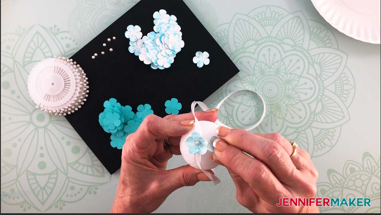 Make a paper hydrangea flower by sticking the petals into the styrofoam ball