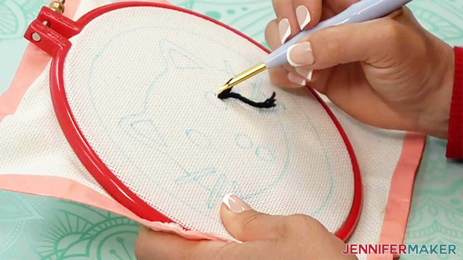Pull the needle back out of the cloth to finish the first stitch of the needle punch design.