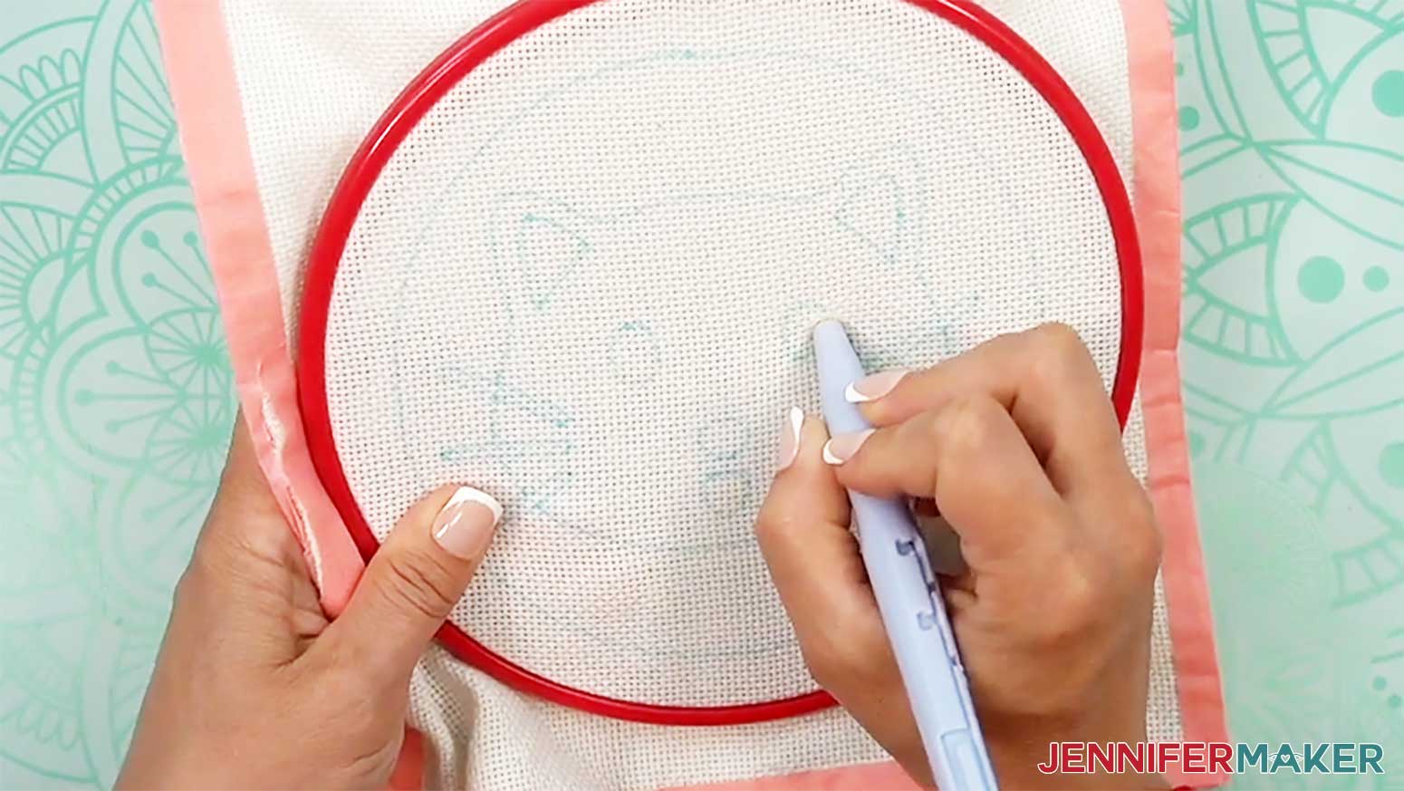 Insert the needle into the cloth and pull it back out to make the first stitch of the punch needle design.