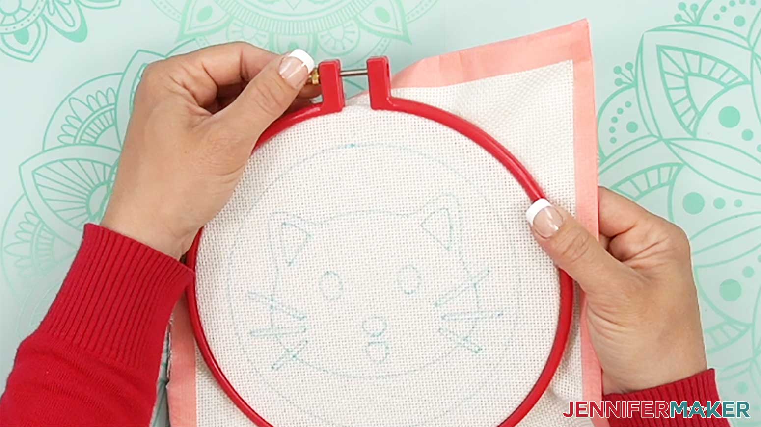 Tighten the top screw to lock the cloth with the punch needle design into place inside the hoop.