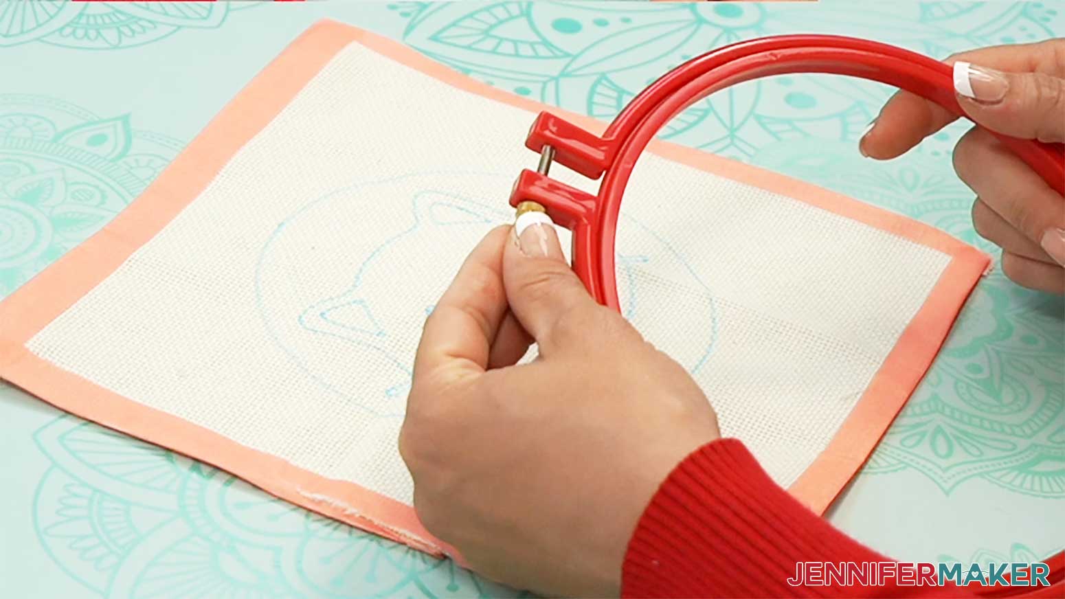 Loosen the screw at the top of the hoop to separate the pieces to insert the cloth with the punch needle design.