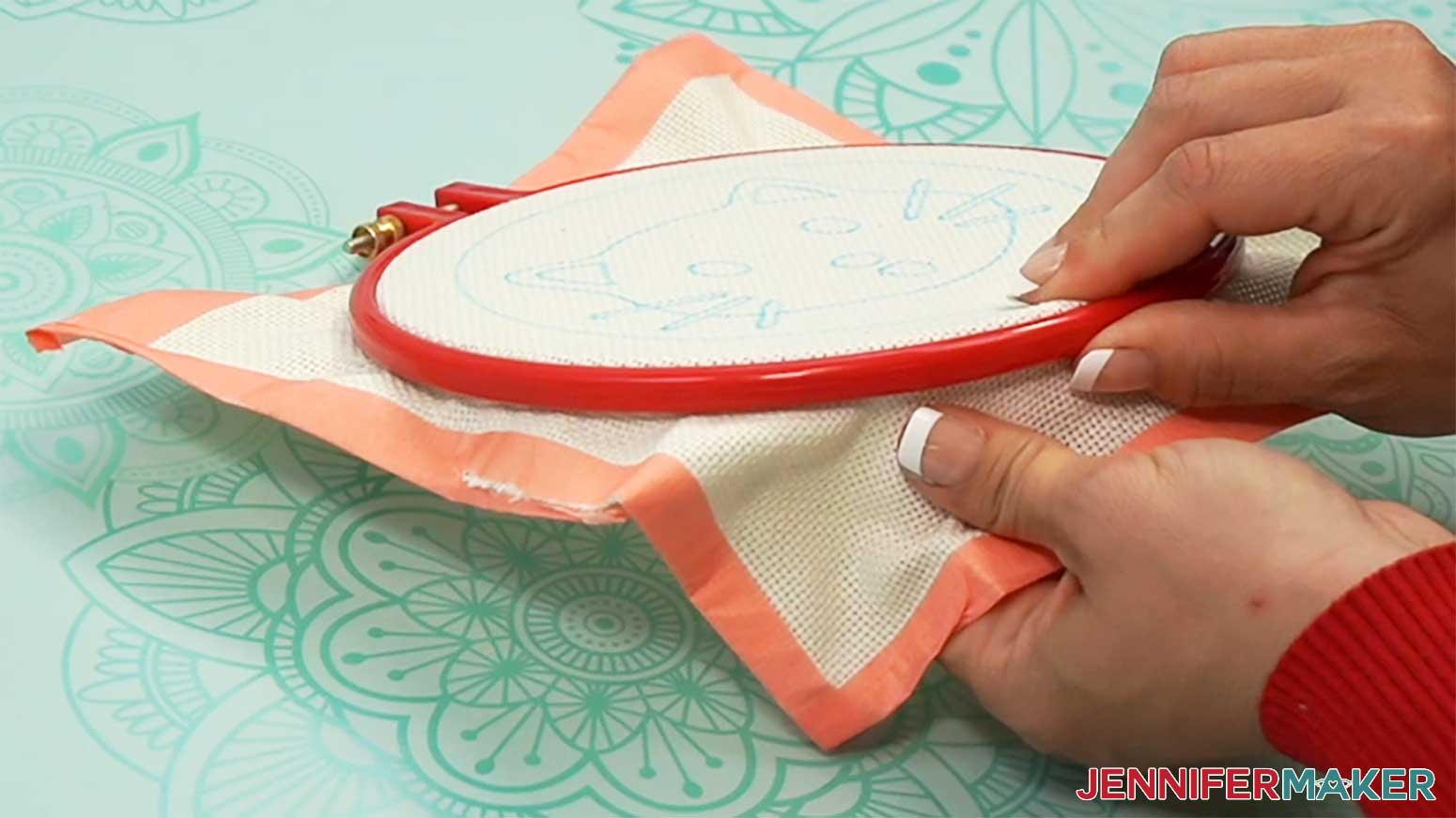 Pull material around the entire hoop to make sure the cloth is tight before stitching the punch needle design.