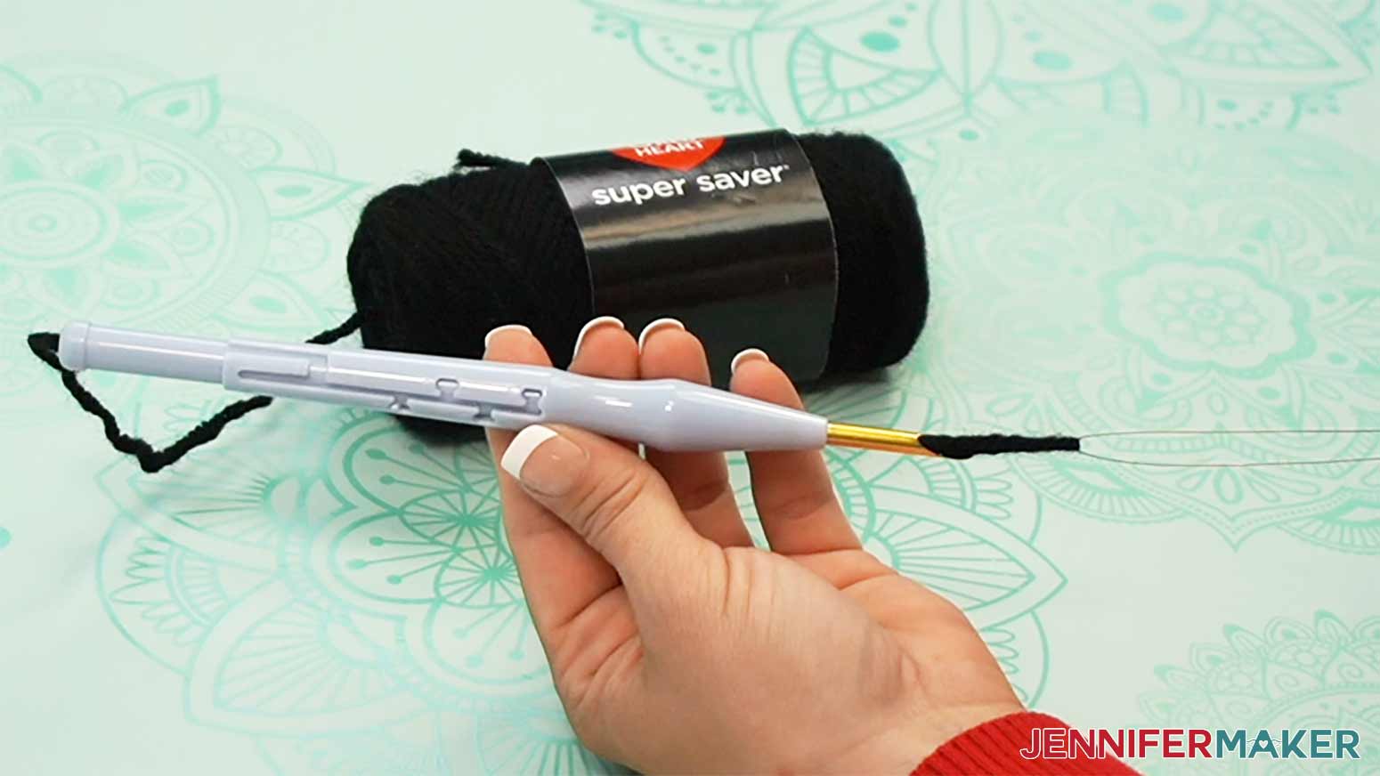Pull the yarn through to the end of the needle to prepare to stitch the punch needle design.