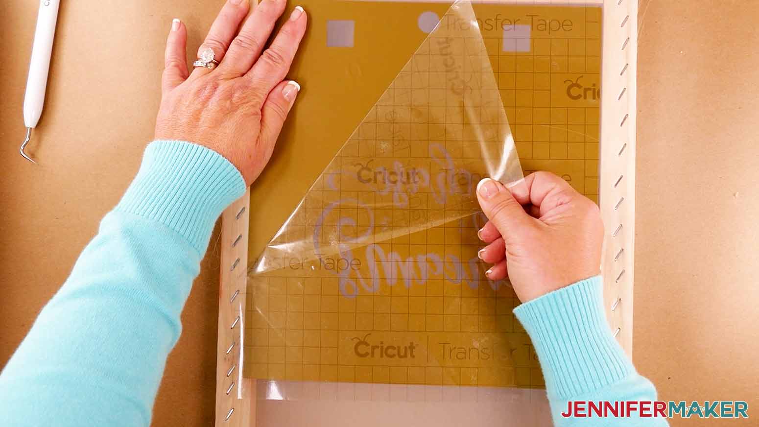 Removing the transfer tape at an angle from the back of a silk screen for the How to Screen Print a Shirt with Cricut project