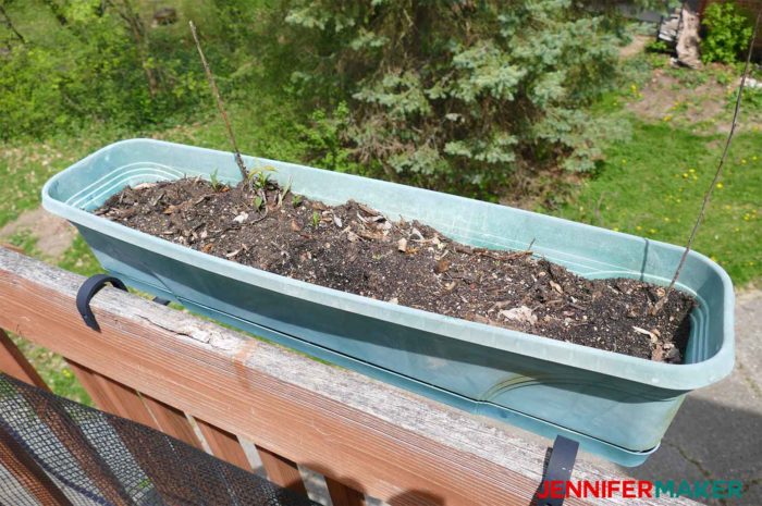 An old and faded plastic planter ready for some TLC and spray paint