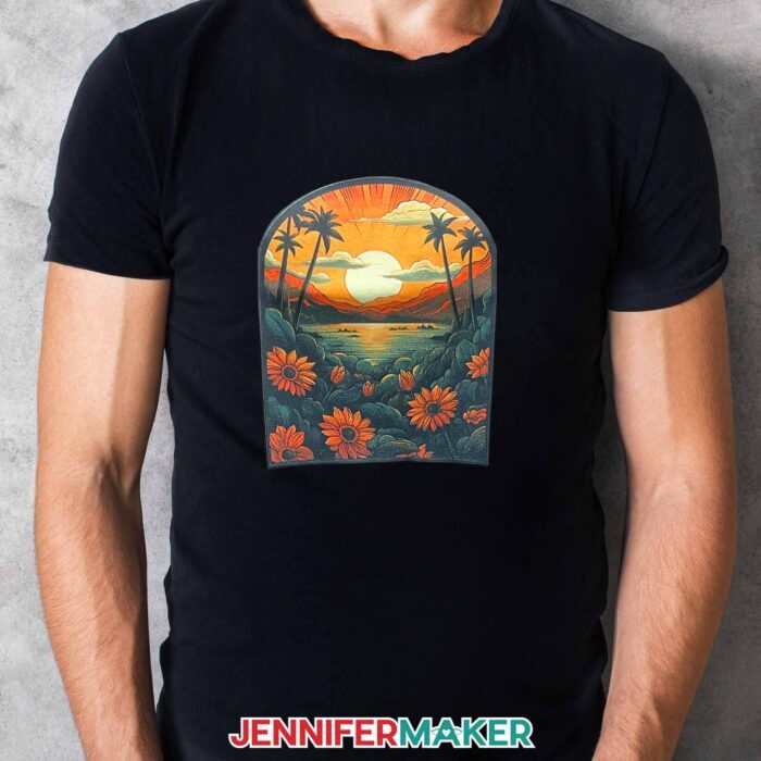 Learn how to sublimate on clear HTV with Jennifer Maker's new tutorial! A man wears a black t-shirt with a brightly colored sunset design sublimated onto the front.