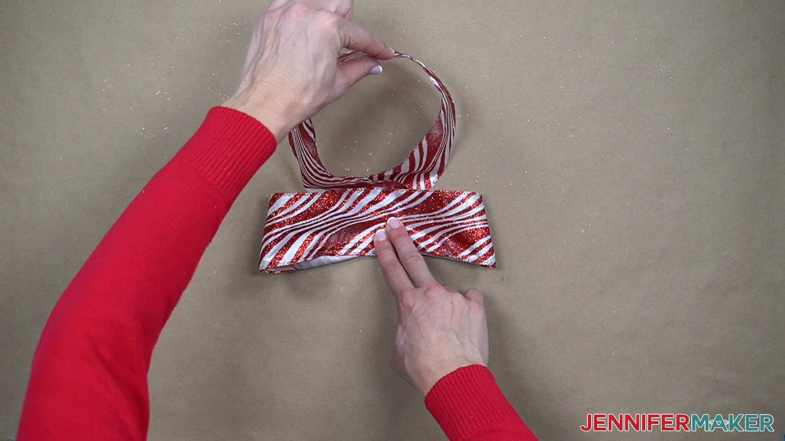 Bring the middle of each loop to the center of the ribbon.