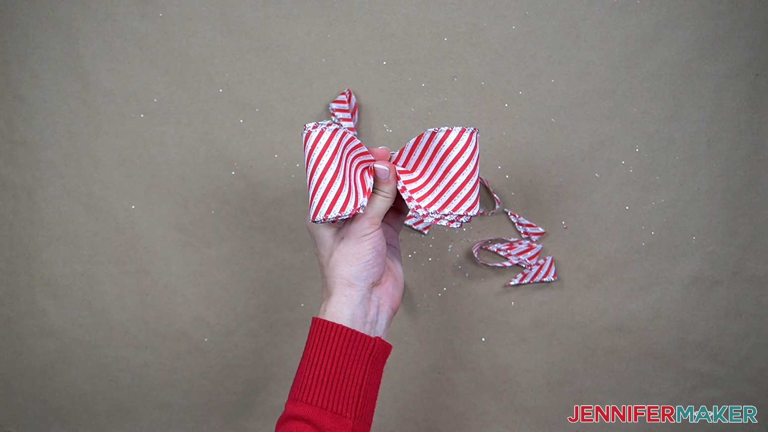 Pinch the loops of ribbon in the middle with the cut edges on either side.