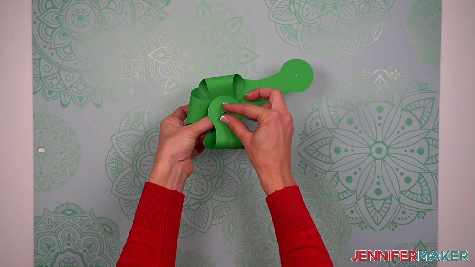 Fold the largest circles of the arms up and place the brad through the centers.