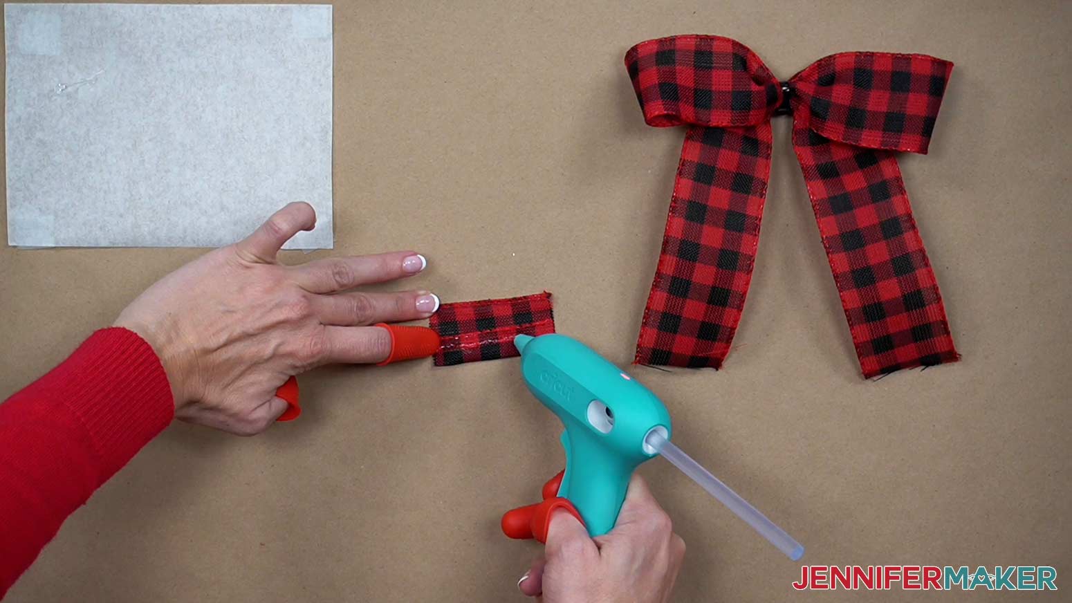 Fold the small rectangle of ribbon onto itself lengthwise and glue to form the top knot.