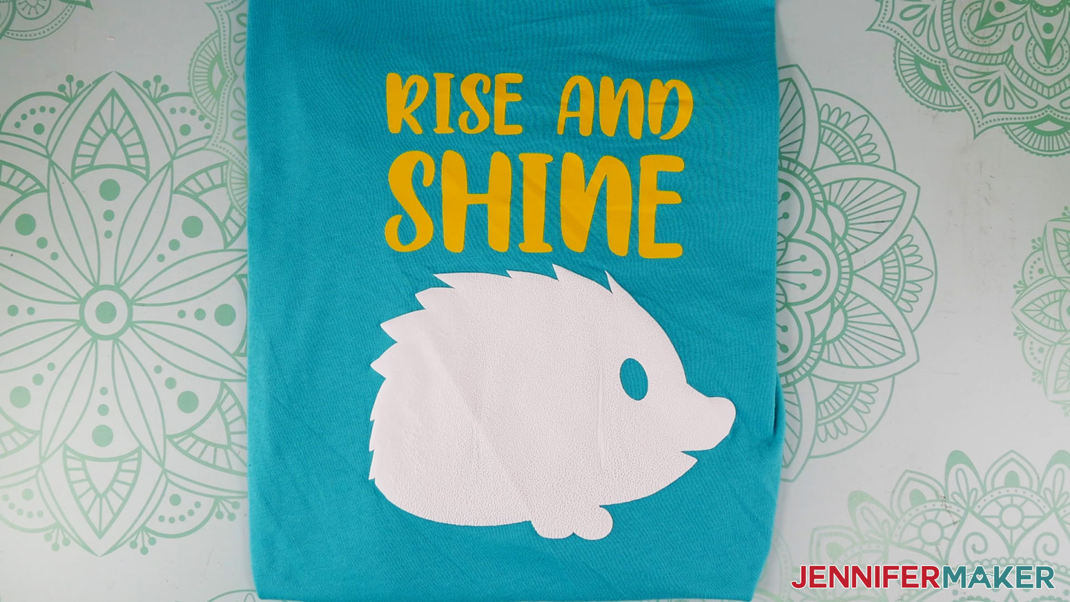 Learn how to use puff vinyl! Turquoise T-shirt with puffy porcupine with yellow "Rise and Shine" text.