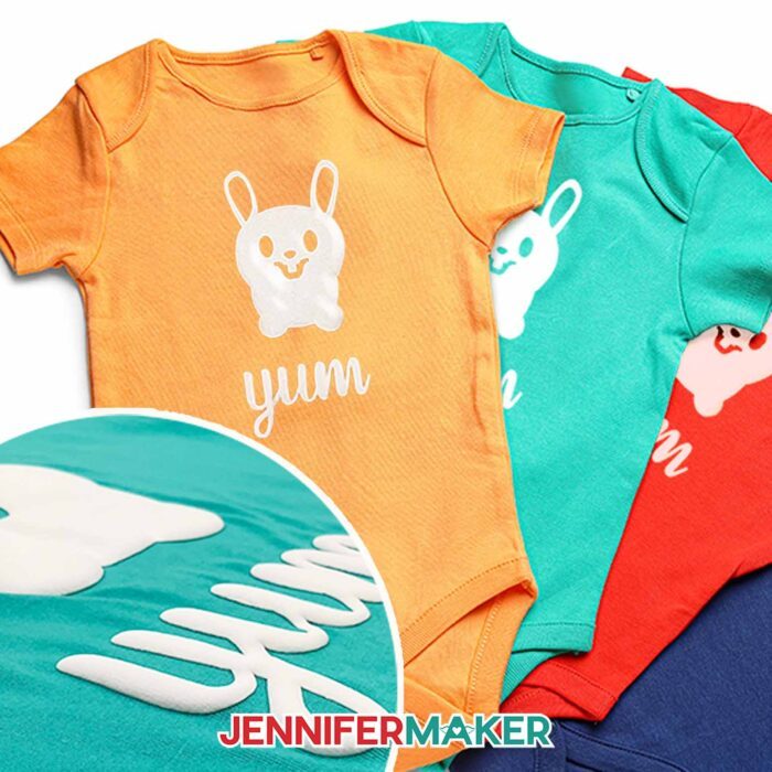 Orange, turquoise, and red baby bodysuits with a cute white puff vinyl bunny and the word "yum". Learn how to use puff vinyl with JenniferMaker's new tutorial!