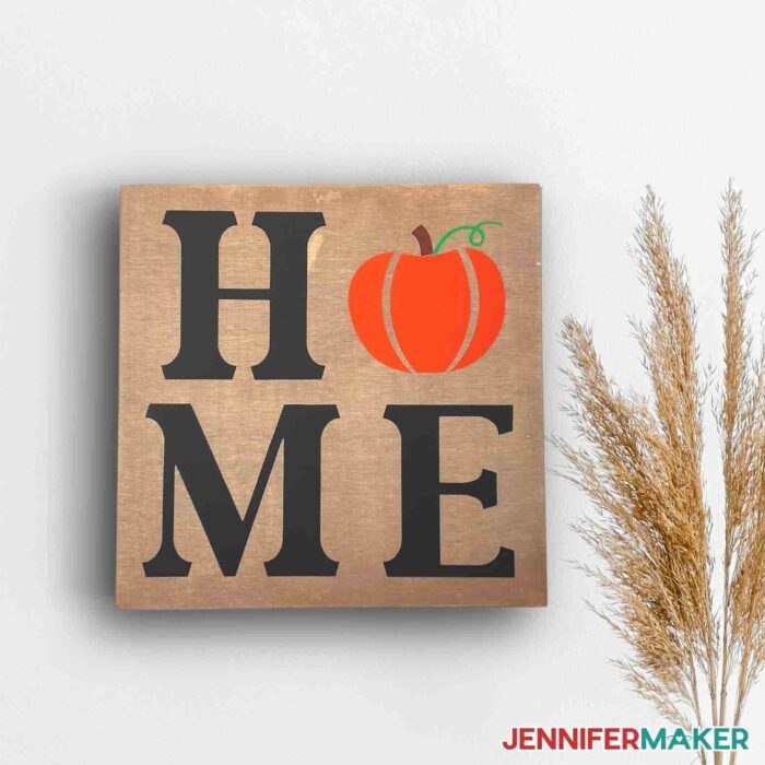 Wooden sign with the word "HOME" on it using HTV