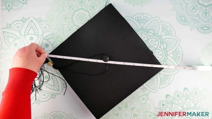 Measure size of graduation cap from left corner to right corner