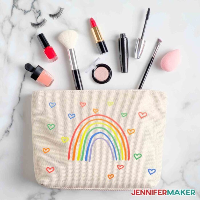 Infusible ink rainbow and hearts on tan makeup bag made using infusible ink pens