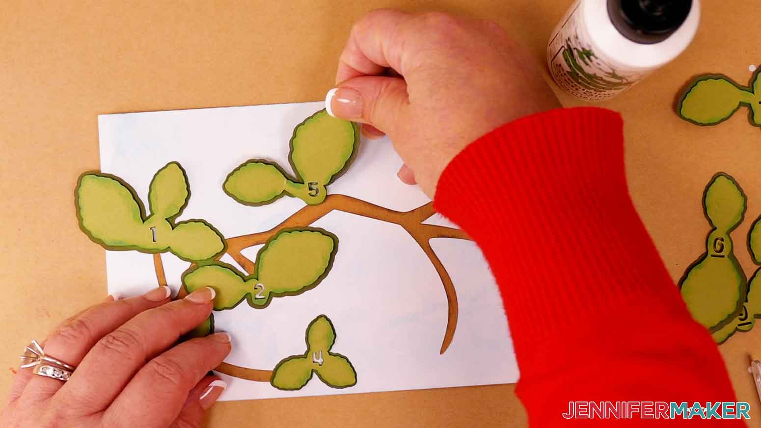 Align the numbers of the leaves and press the lighter green leaves on to the dark green leaf pieces.