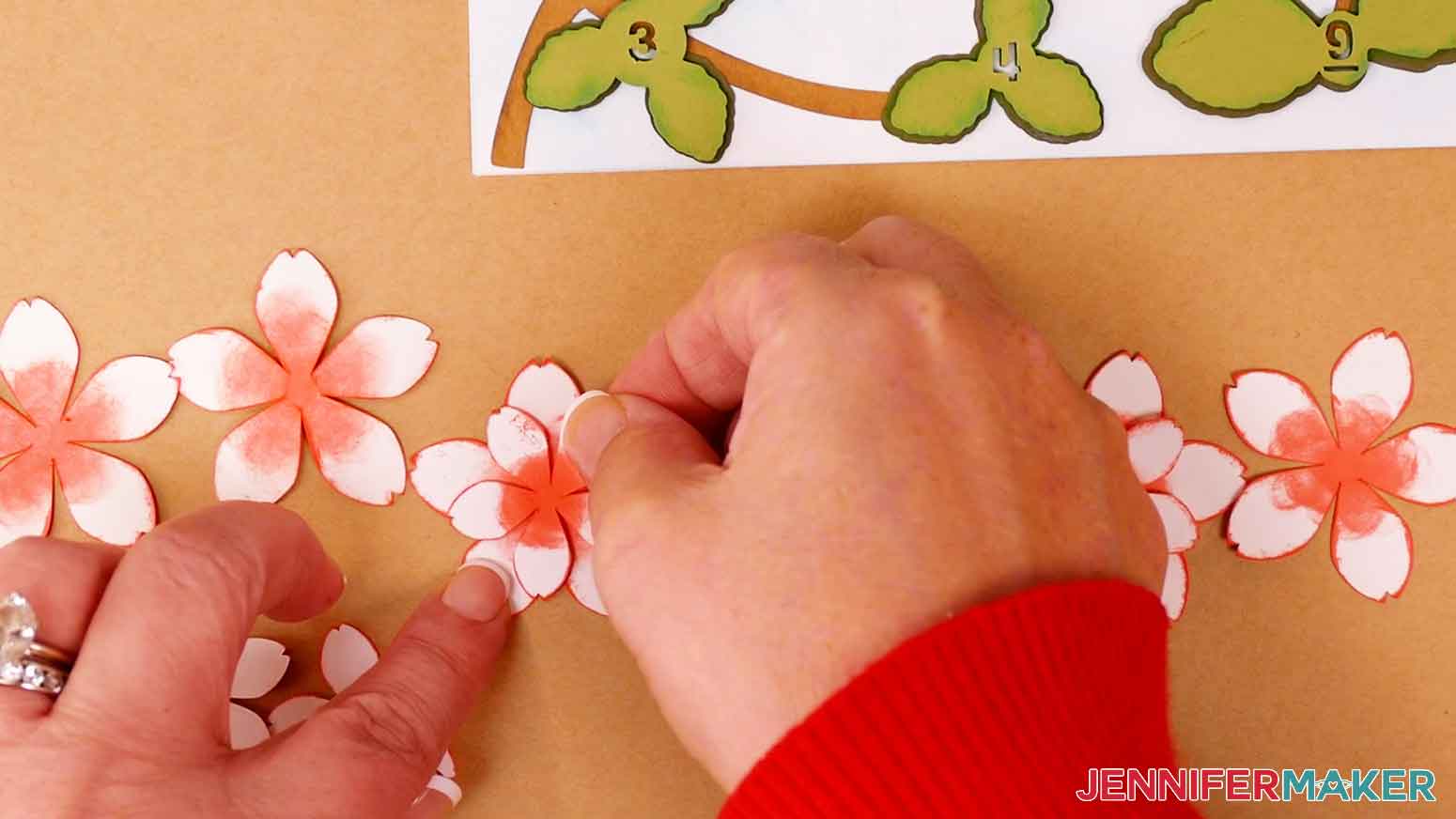 Place foam adhesive on the back of the front cherry blossom petals and press the petal layers together.