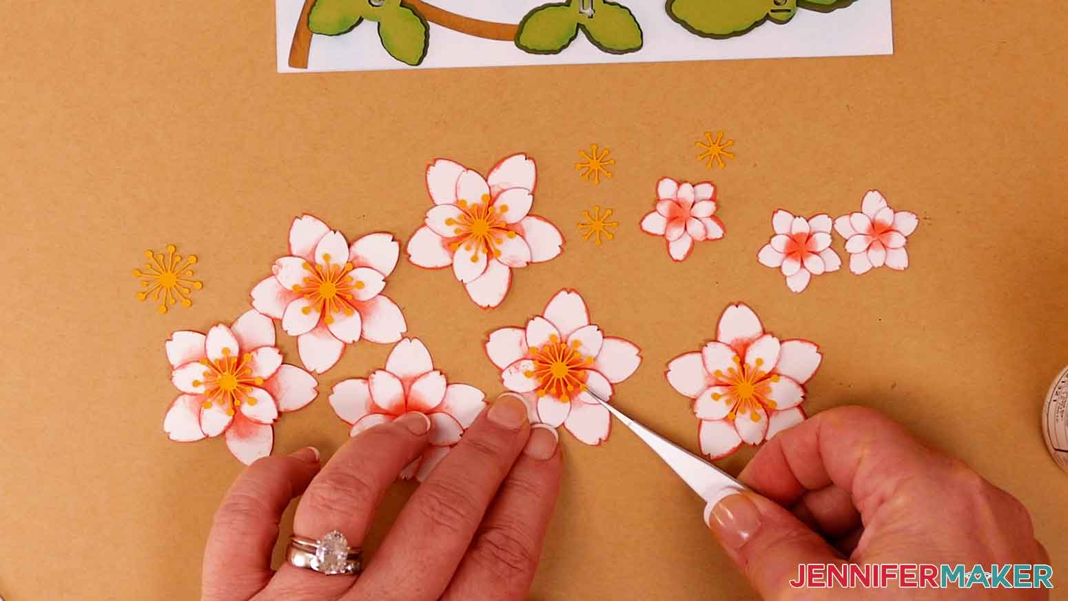 Use craft glue to attach the stamens to the cherry blossom flowers.