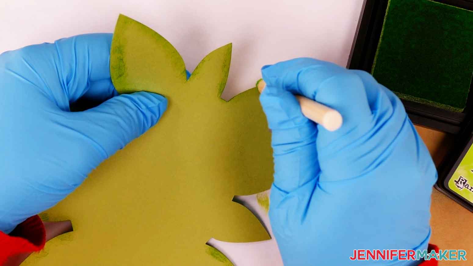 Apply light green distress ink to the cardstock edges of the light green leaf layer.