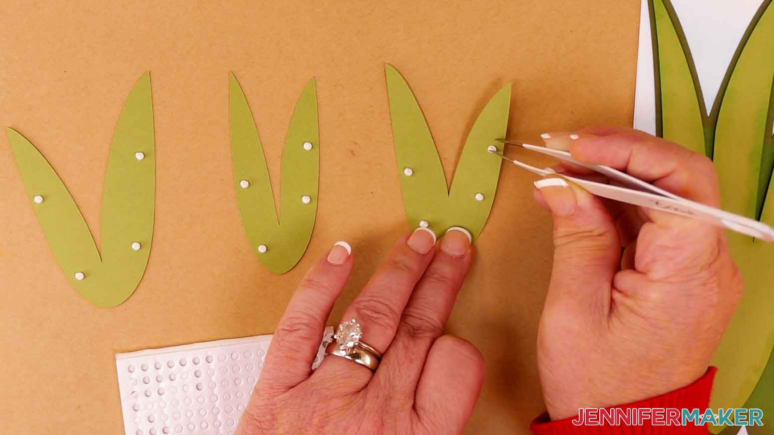 Apply foam adhesive to the back of the front light green leaves of the tulip design.