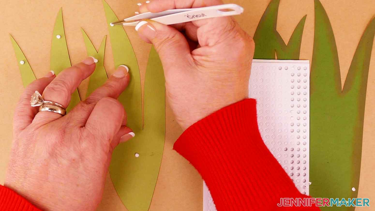 Use tweezers to apply foam adhesive to the back side of the light green leaves.