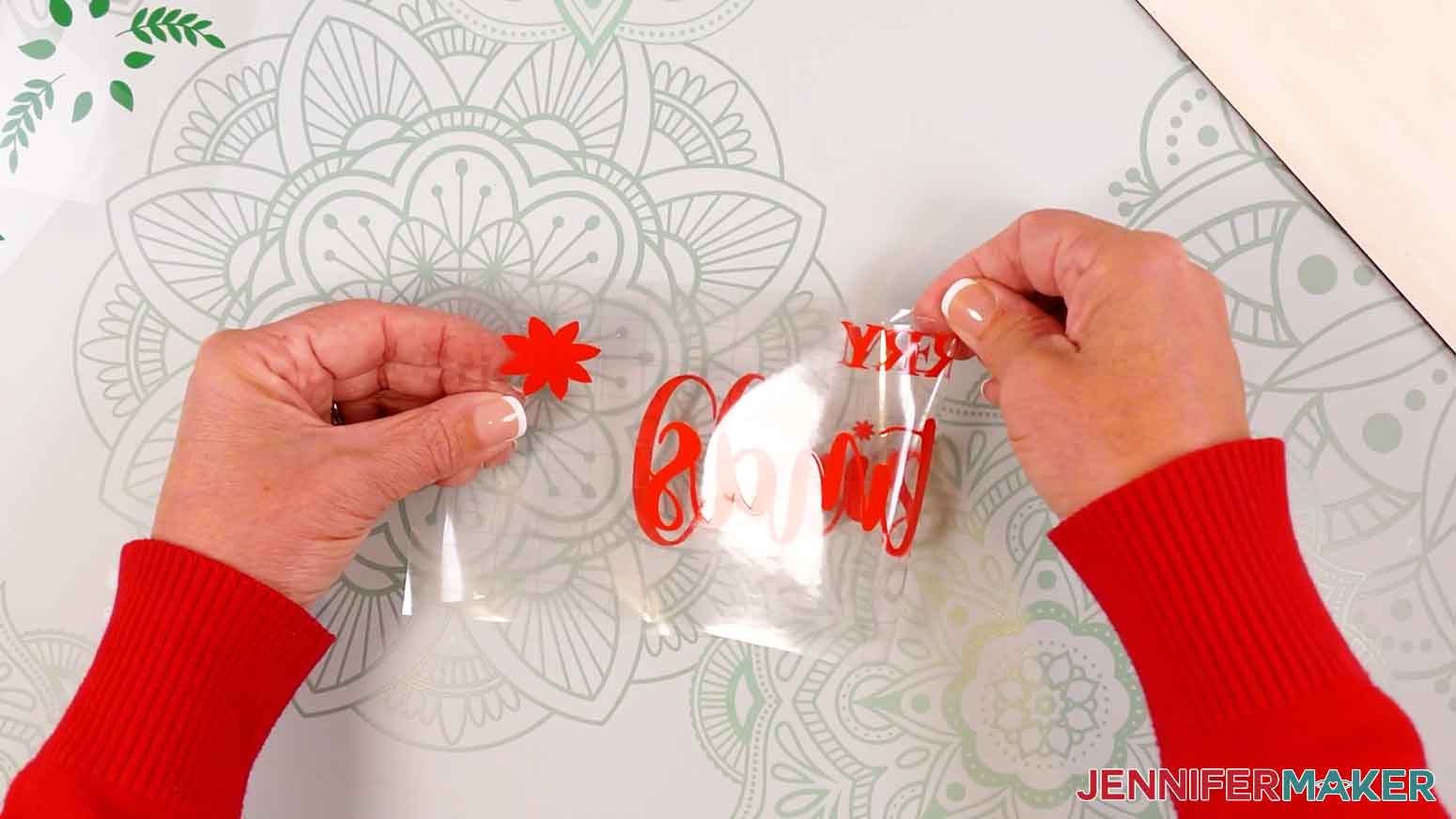 Fold the design in half and crease the top of the transfer tape to help with aligning the design on the wood panel.