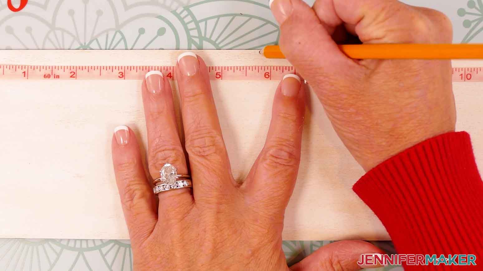 Use a ruler and pencil to lightly mark the center of the wood panel.