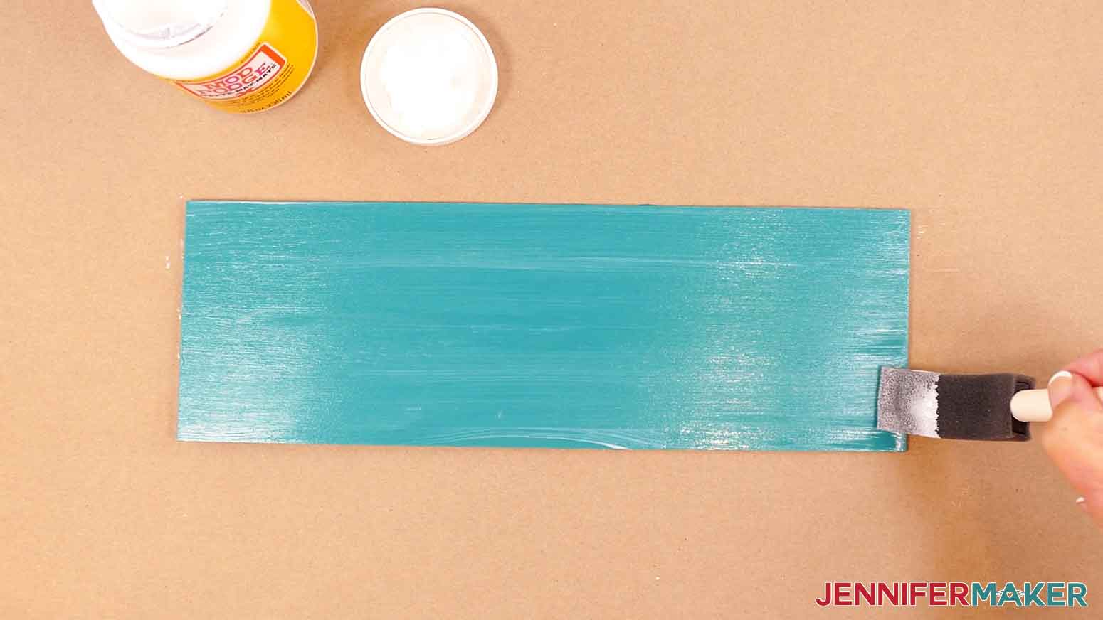 Use a foam paint brush to apply matte Mod Podge sealer to the painted wood board.