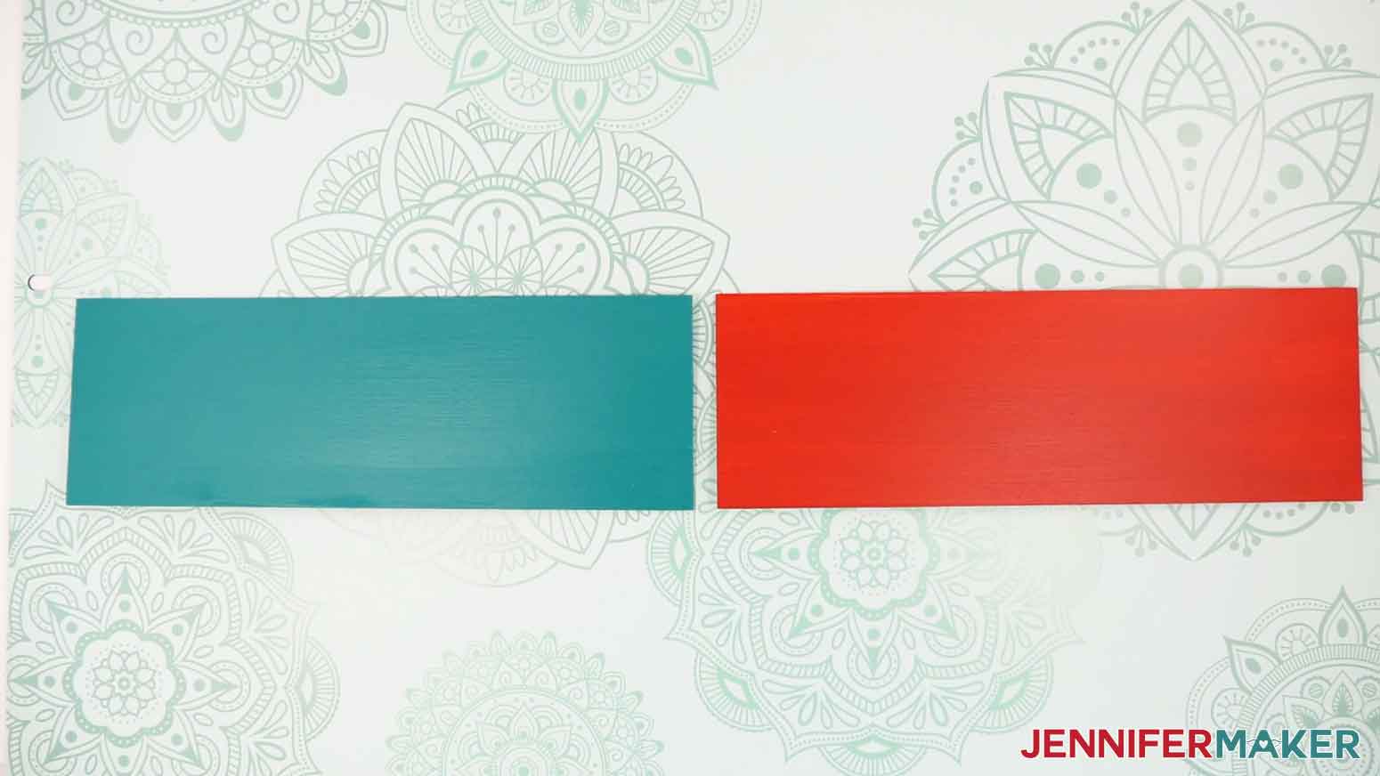Two wood panels painted with solid teal and red chalk paint.
