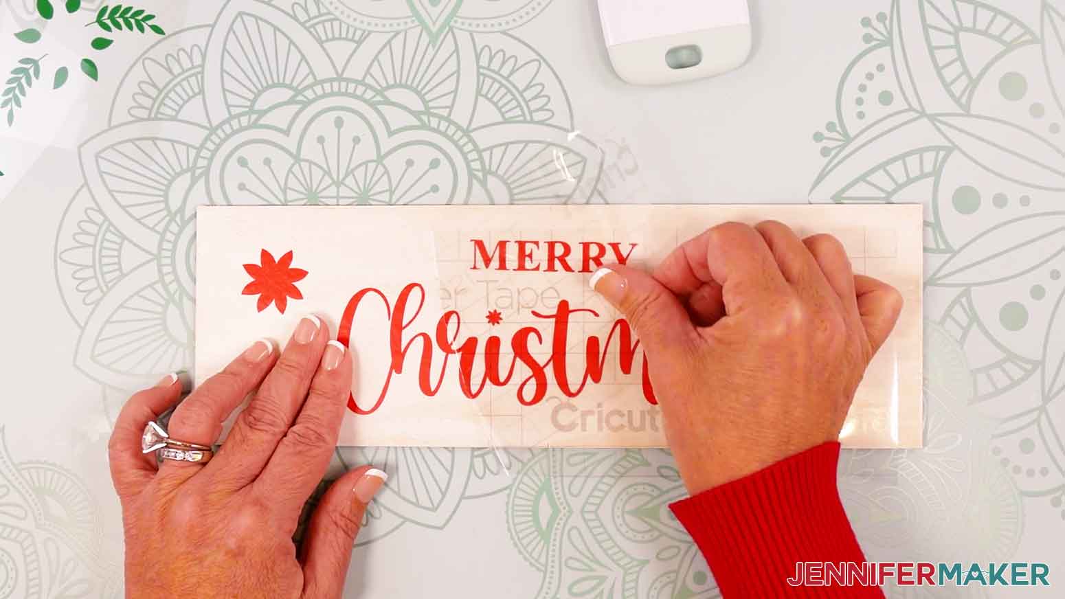 Gently peel away the transfer tape from the vinyl design.