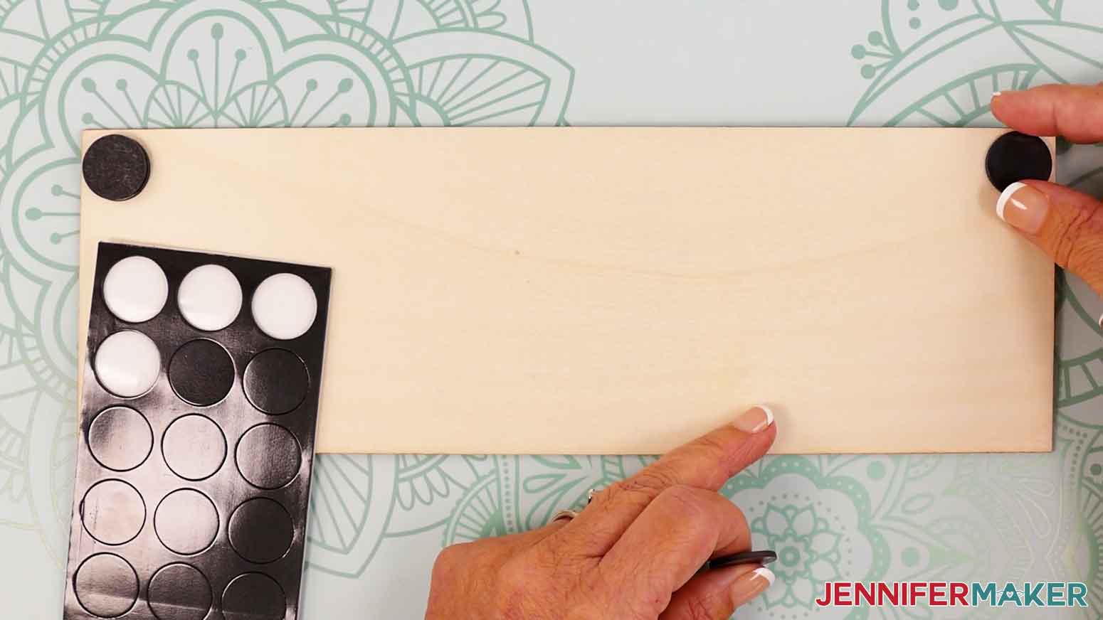 Place the second adhesive magnet to the upper right corner of the wood panel.
