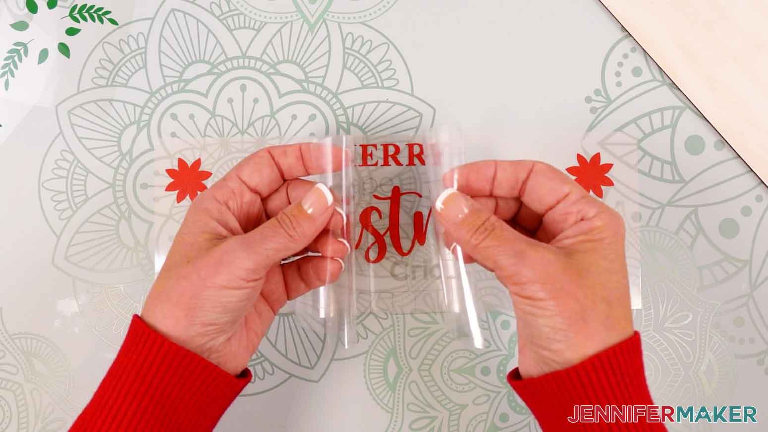 Use the taco method to fold up the sides of the transfer tape and lower the center on to the vinyl design.