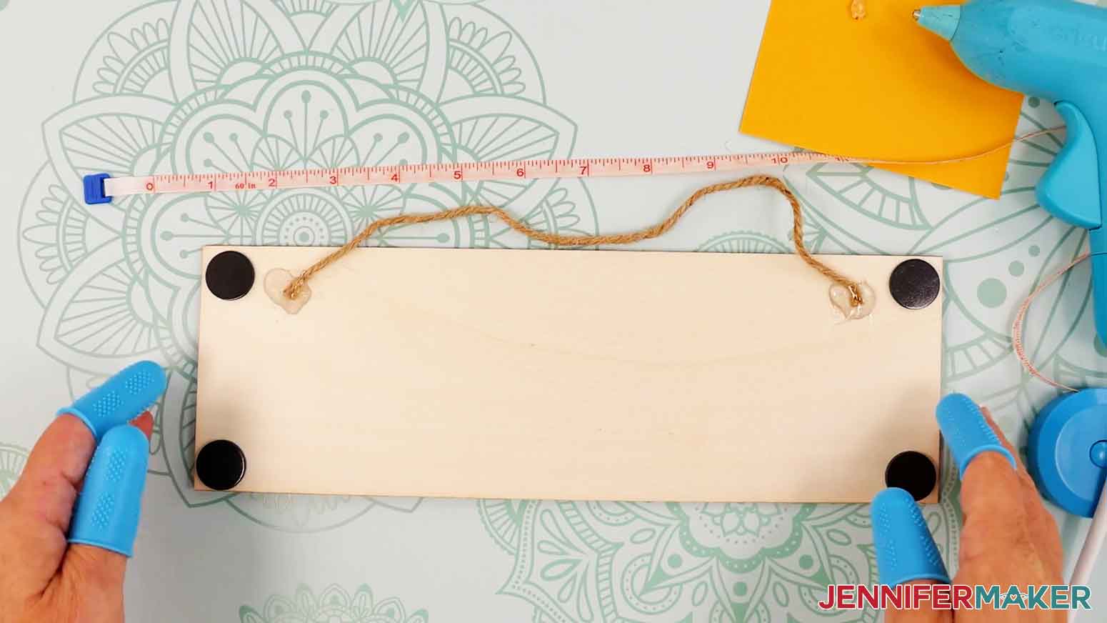 Apply hot glue to the right side and press the twine into the glue. Allow the glue to fully dry.