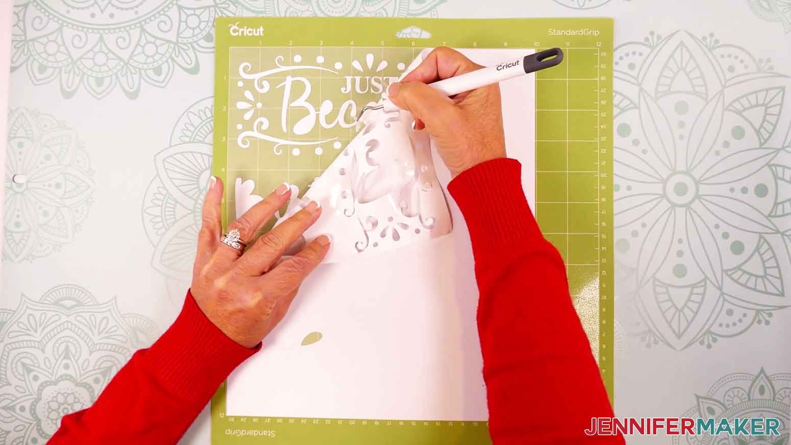 Use a weeding tool to remove the excess vinyl from the design.