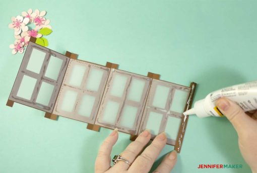 Putting glue on the folded end tab of the Japanese paper lantern