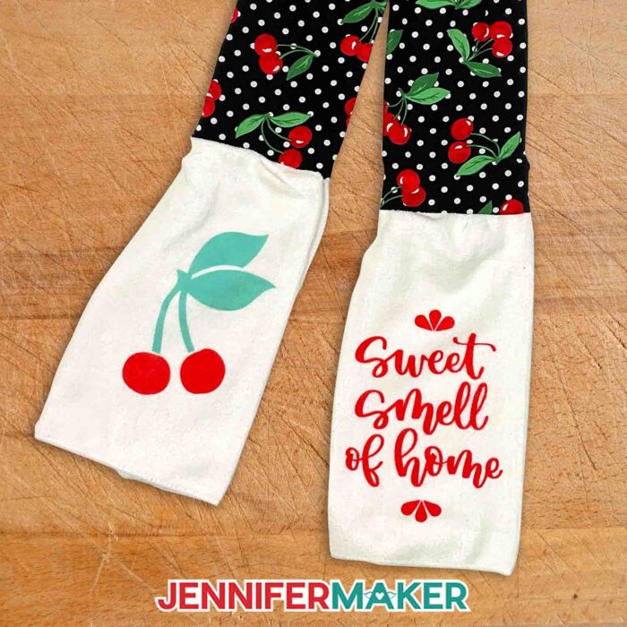 Kitchen boa scarf with black polka dot cherry fabric for the neck, Infusible Ink cherries on one towel end, and a brush script "sweet smell of home" on the other.