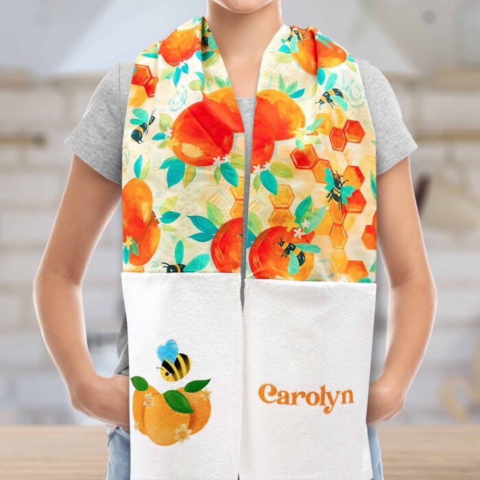 Person wearing a kitchen boa scarf with orange fabric and custom print sublimation designs.