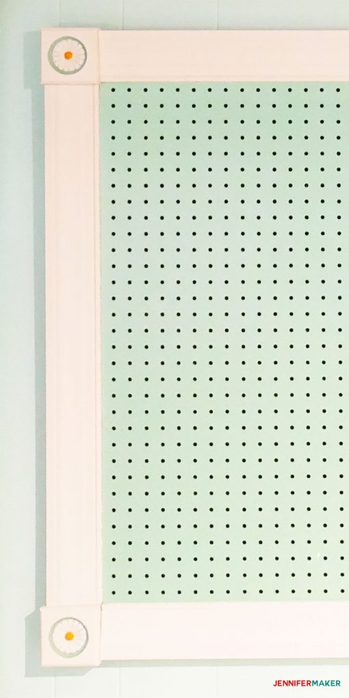 Close-up of large framed pegboard with flower rosettes