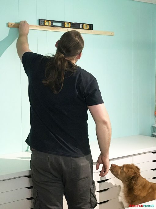 Screwing in the mounting boards with drywall screws for our large framed pegboard