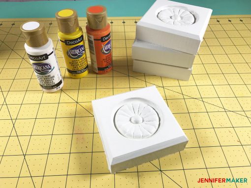 Painting the rosettes white for my large framed pegboard