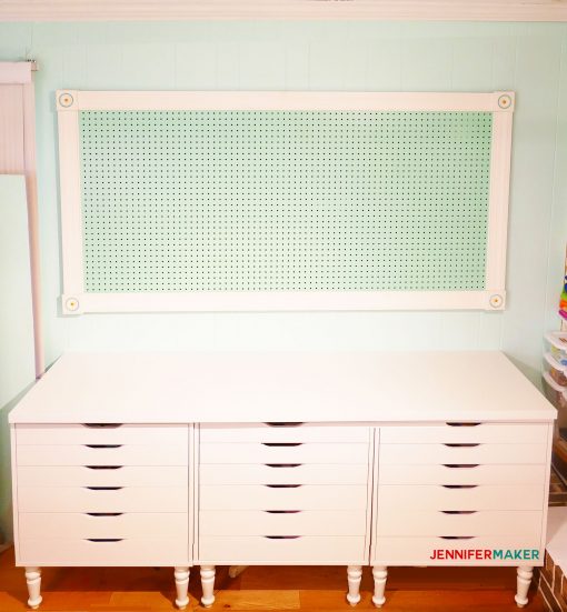 Large Framed Pegboard mounted up on the wall with screw holes patched with wood filler