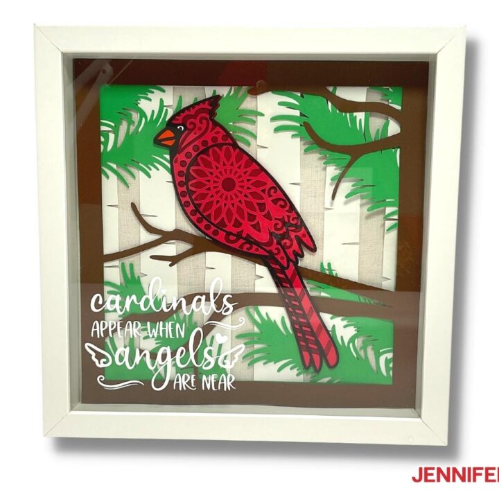 Cardsock layered cardinal SVG project in a white shadow box frame.