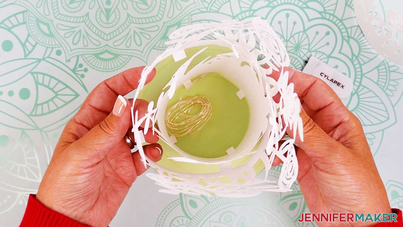 Gently work the middle layer down over the inner layer and place it on the base.