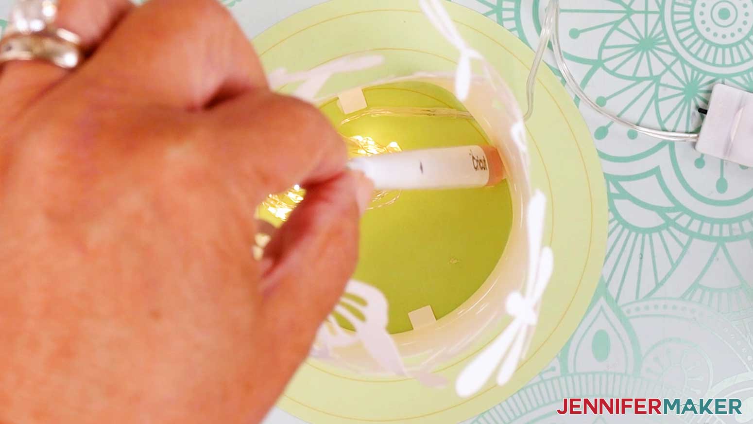Apply a dot of glue to the underside of the second tab on the innermost lantern layer and press it in to place.