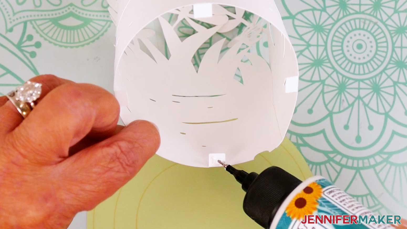 Add a dab of craft glue to the bottom of the first tab on the inner most garden lantern layer.