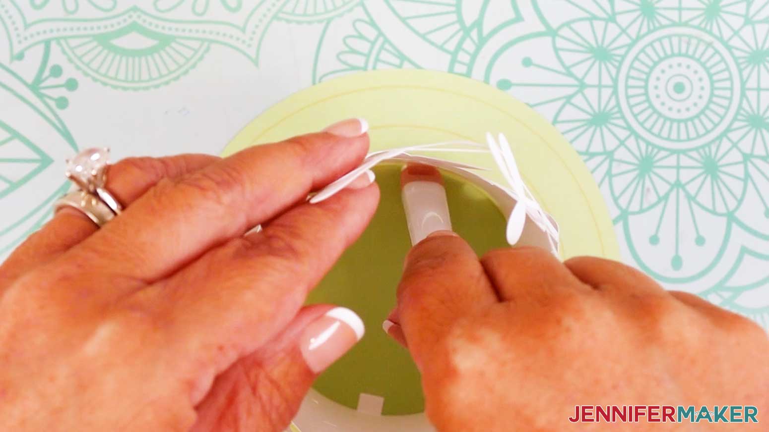 Press the first glued tab on the innermost layer to the innermost circle on the base.