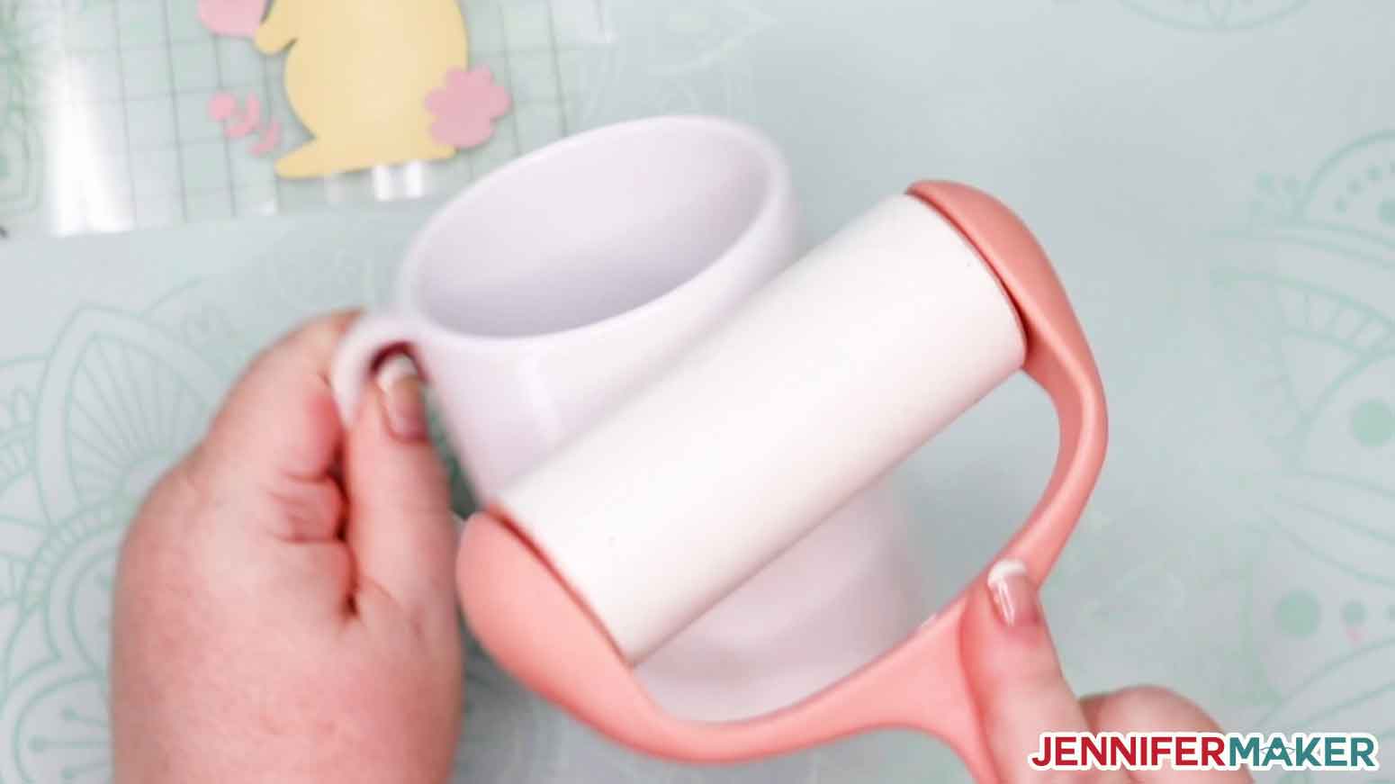 Cleaning a mug with a lint roller before applying the infusible Ink