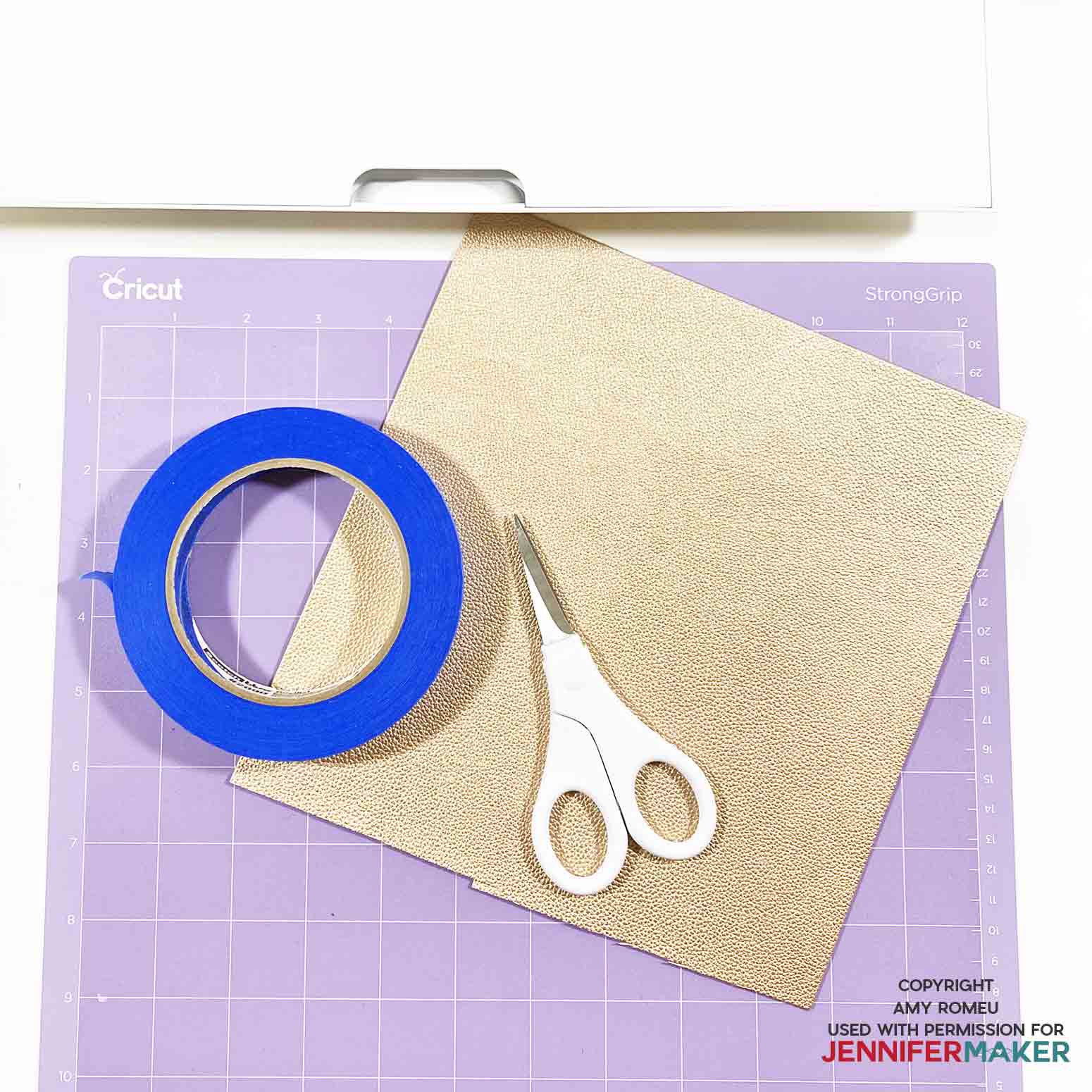 faux leather, purple Cricut cutting mat, scissors and tape