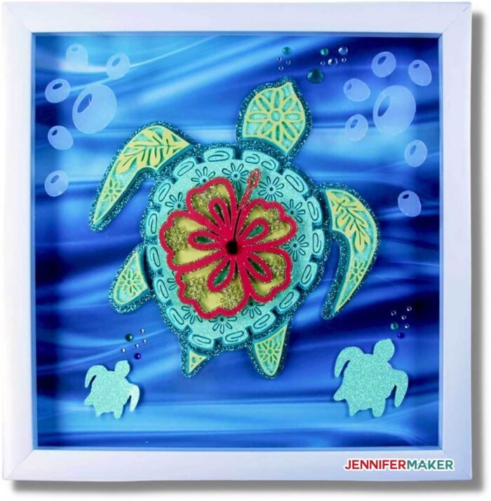 Layered Turtle Mandala in green and blue cardstock with vinyl accents, framed in a white shadow box