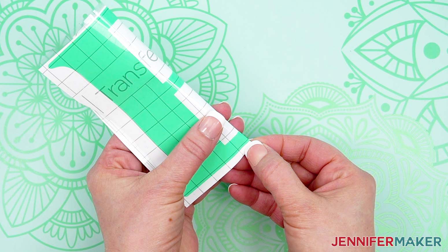 Fold the vinyl letter to gently crease the transfer tape at the vertical and horizontal centers.